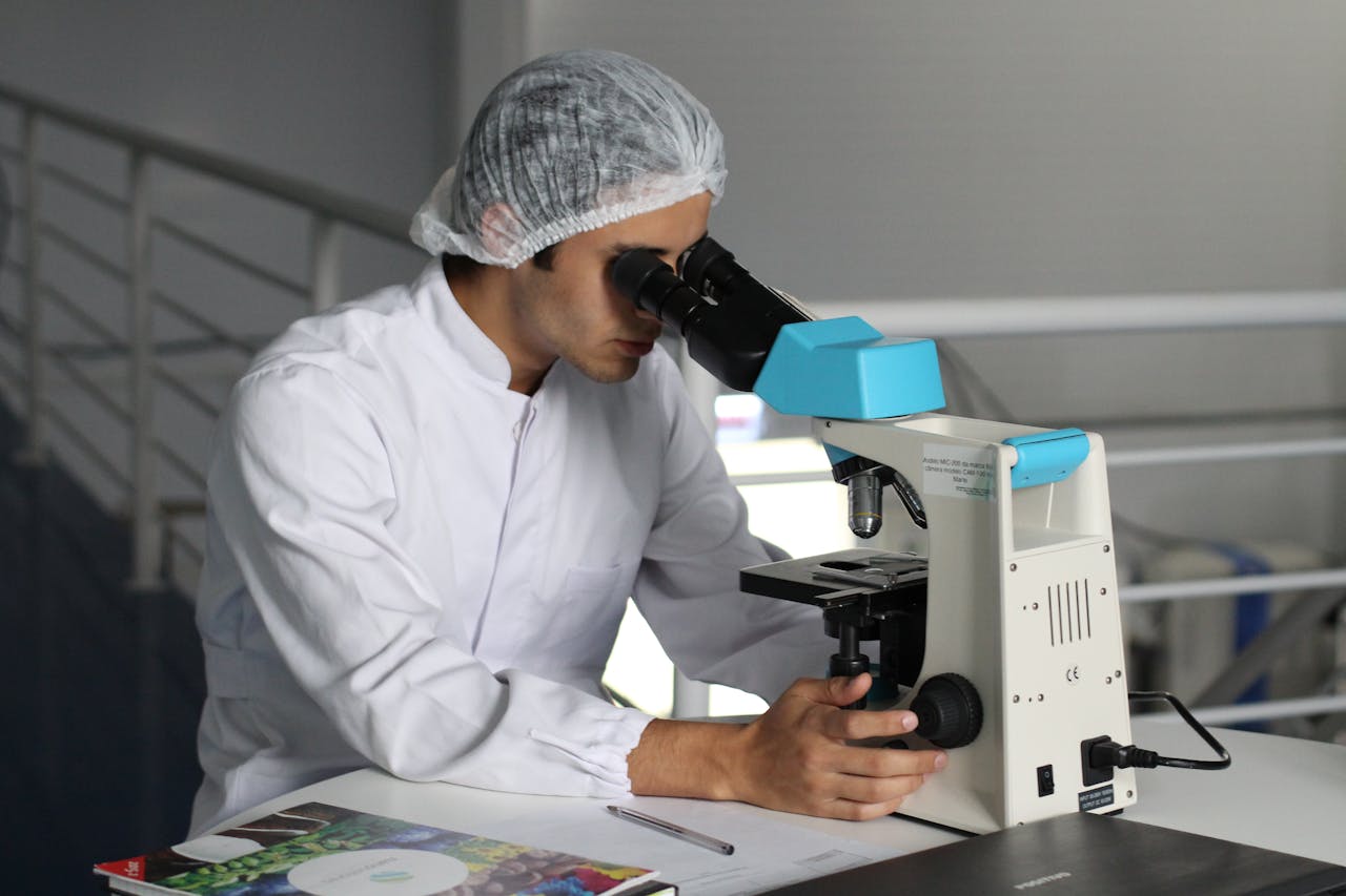 man looking into microscope